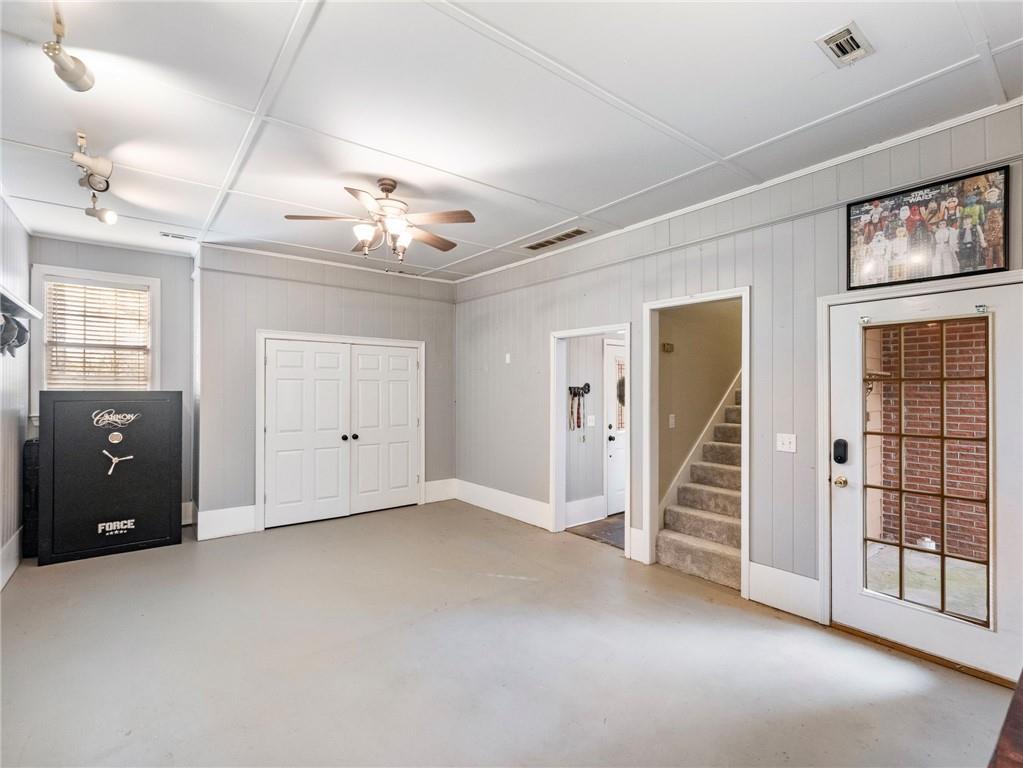 945 Poplar Street Monroe, GA 30655 - Photo 23 of 55 en empty room with windows and ceiling fan