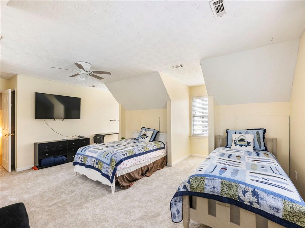 945 Poplar Street Monroe, GA 30655 - Photo 29 of 55 a bedroom with a bed and flat screen tv