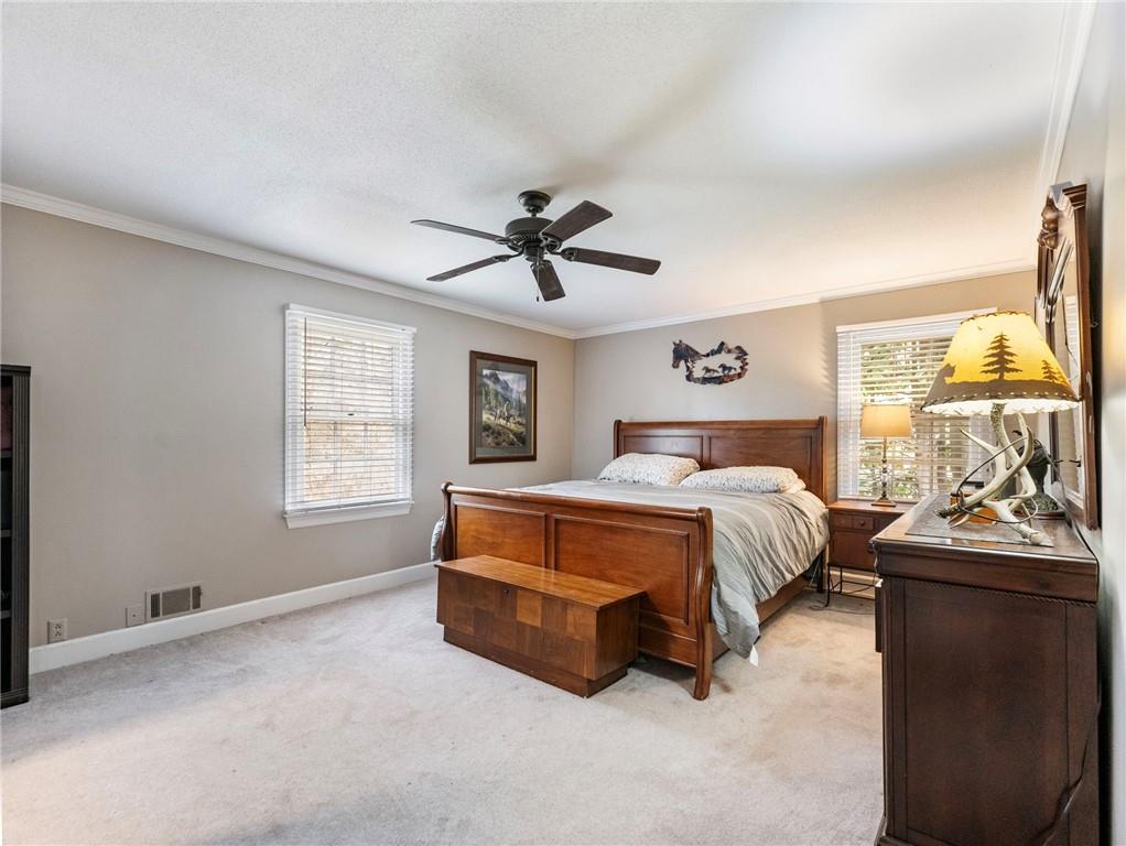 945 Poplar Street Monroe, GA 30655 - Photo 37 of 55 a bedroom with a bed and a chandelier