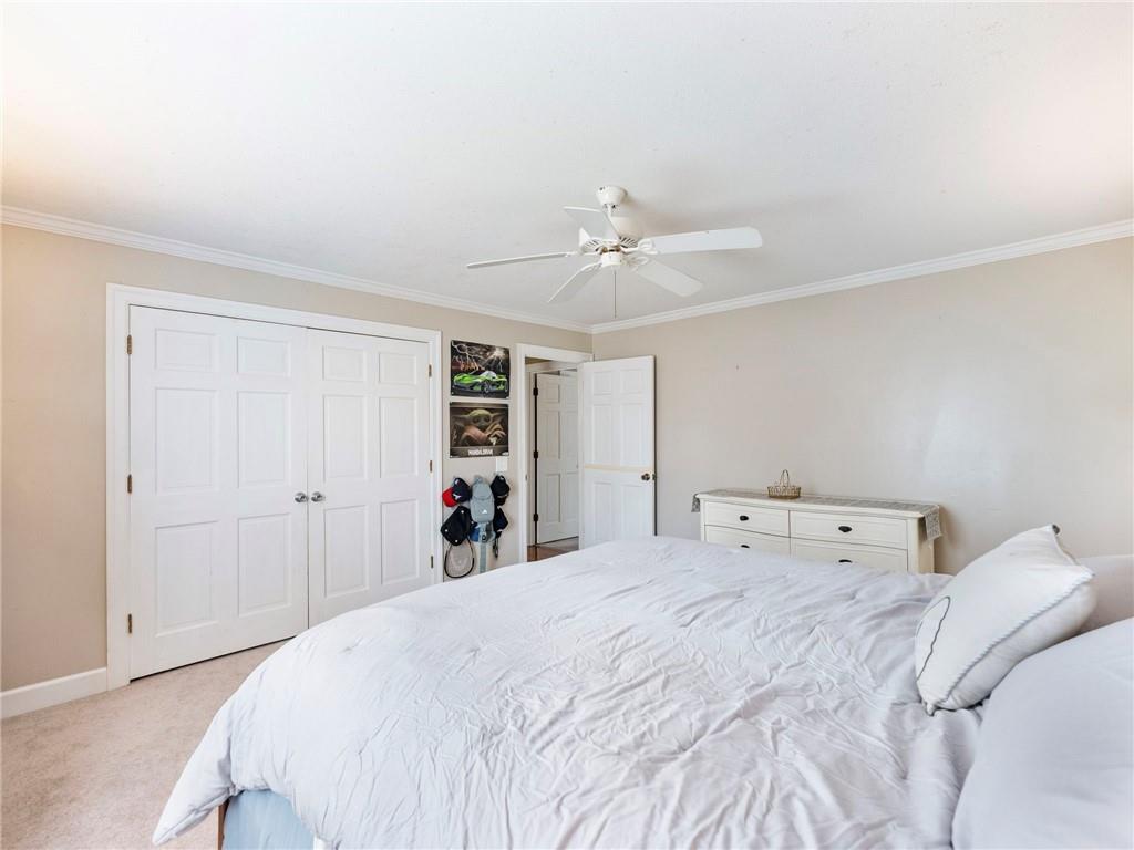 945 Poplar Street Monroe, GA 30655 - Photo 41 of 55 a bedroom with a bed and a chandelier
