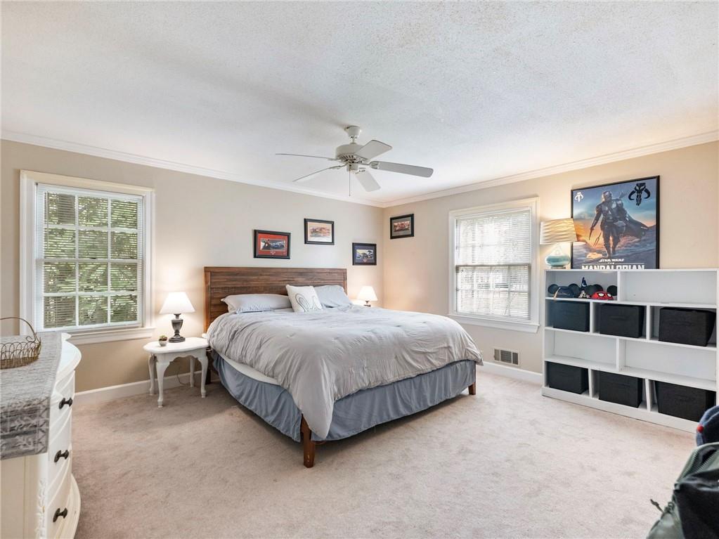 945 Poplar Street Monroe, GA 30655 - Photo 42 of 55 a spacious bedroom with a bed and a large window