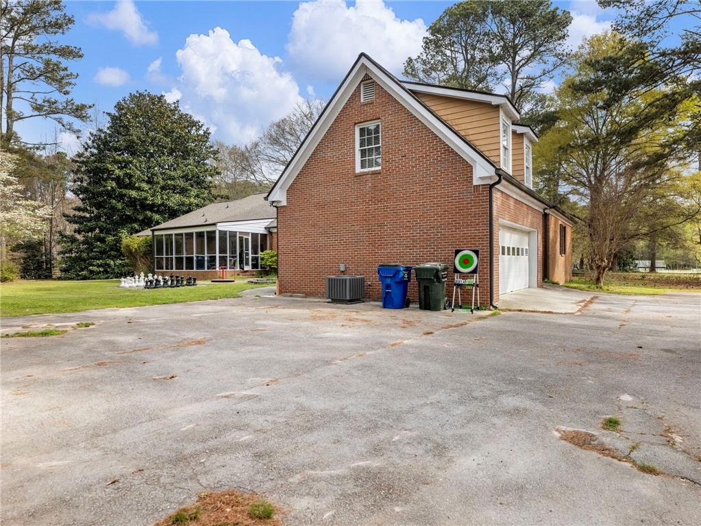 945 Poplar Street Monroe, GA 30655 - Photo 45 of 55 a front view of a house with a yard and garage