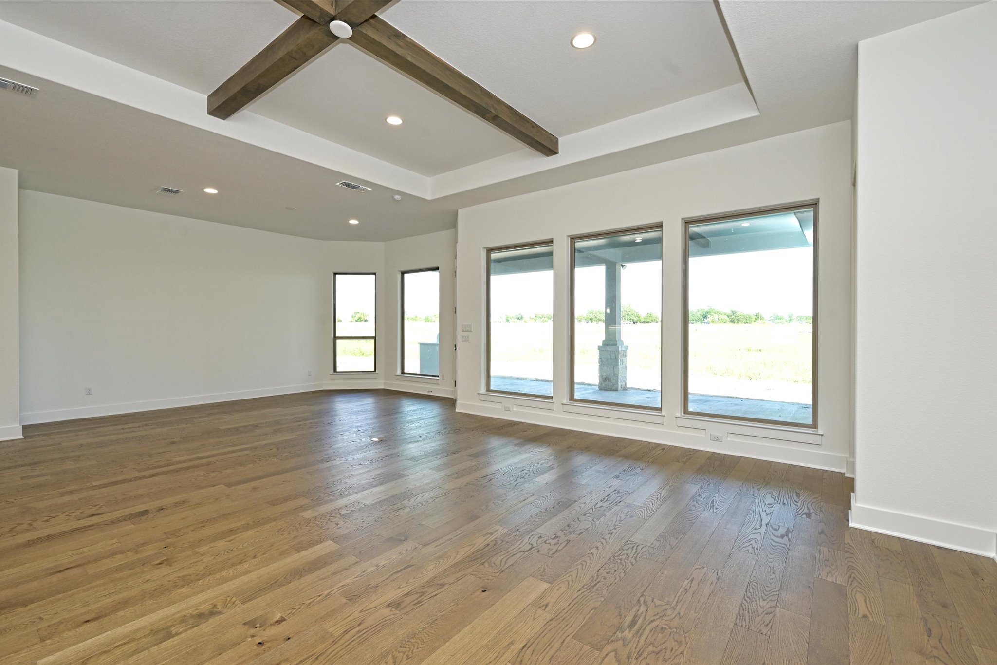 209 Scofield Avenue Georgetown, TX 78626 - Photo 3 of 33 a view of an empty room with wooden floor and a window