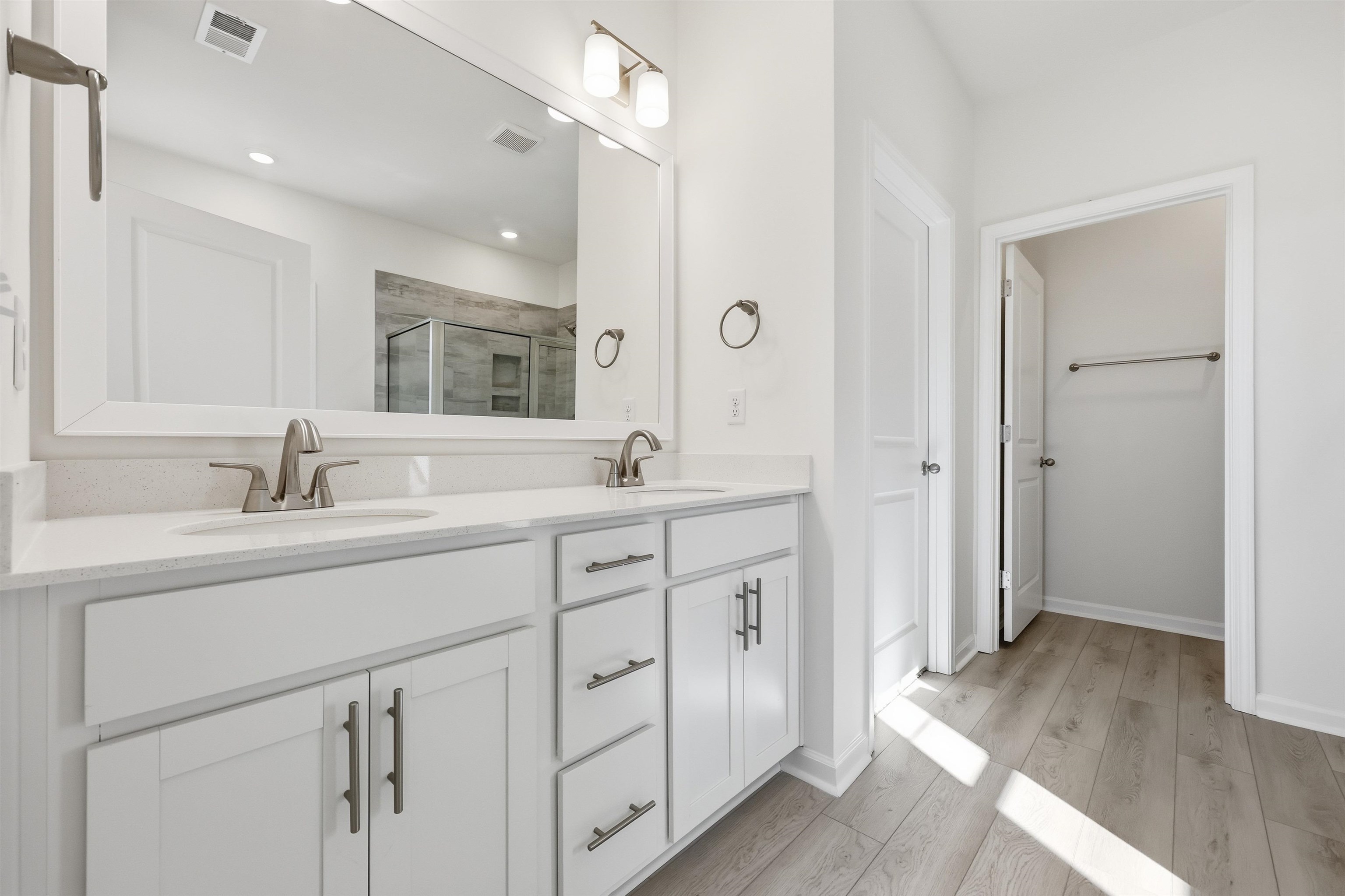141 River Birch Drive Loris, SC 29569 - Photo 11 of 37 Full bathroom featuring a shower stall, light wood finished floors, and double vanity