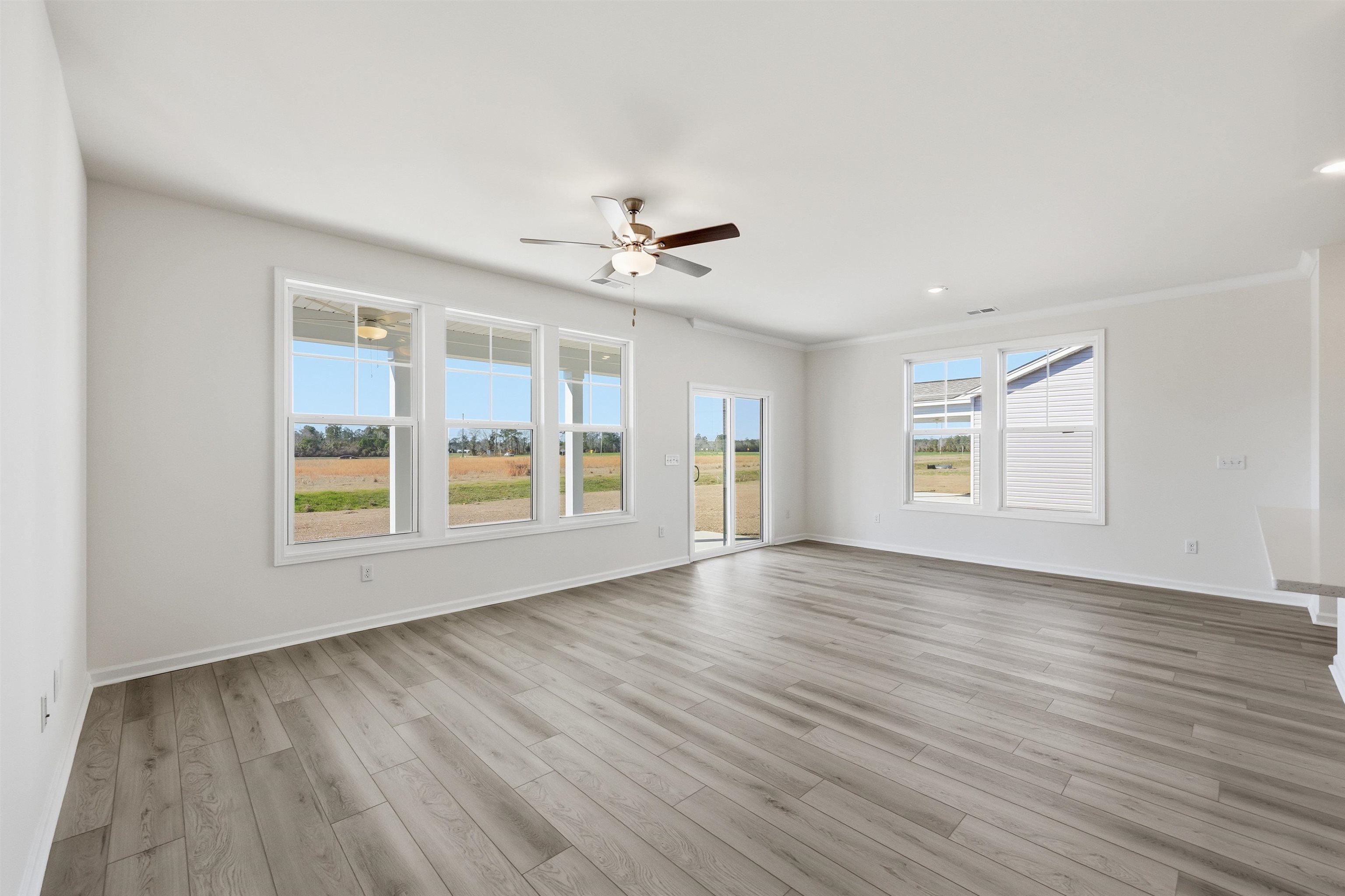141 River Birch Drive Loris, SC 29569 - Photo 4 of 37 Spare room featuring light wood-style floors, ceiling fan, healthy amount of natural light, ornamental molding, and recessed lighting