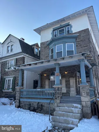 a front view of a house with iron fence