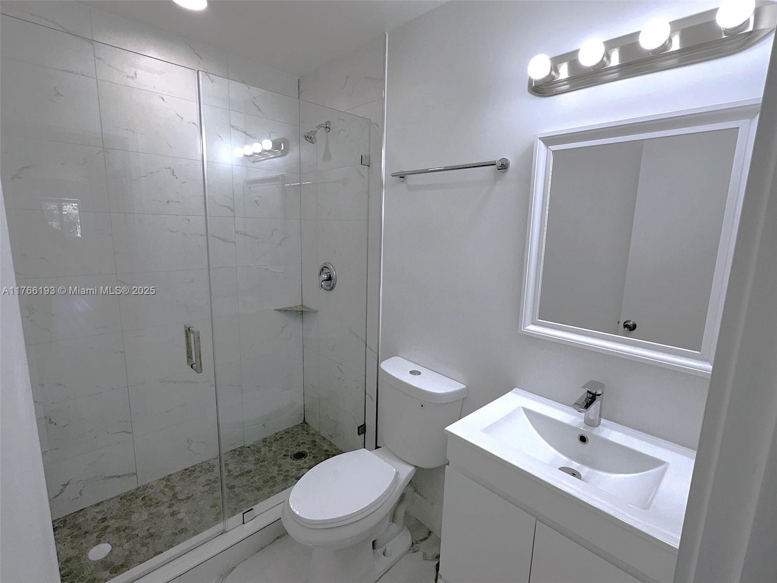 11232 Southwest 5th Street, Unit 2 Sweetwater, FL 33174 - Photo 15 of 24 a bathroom with a sink toilet and shower