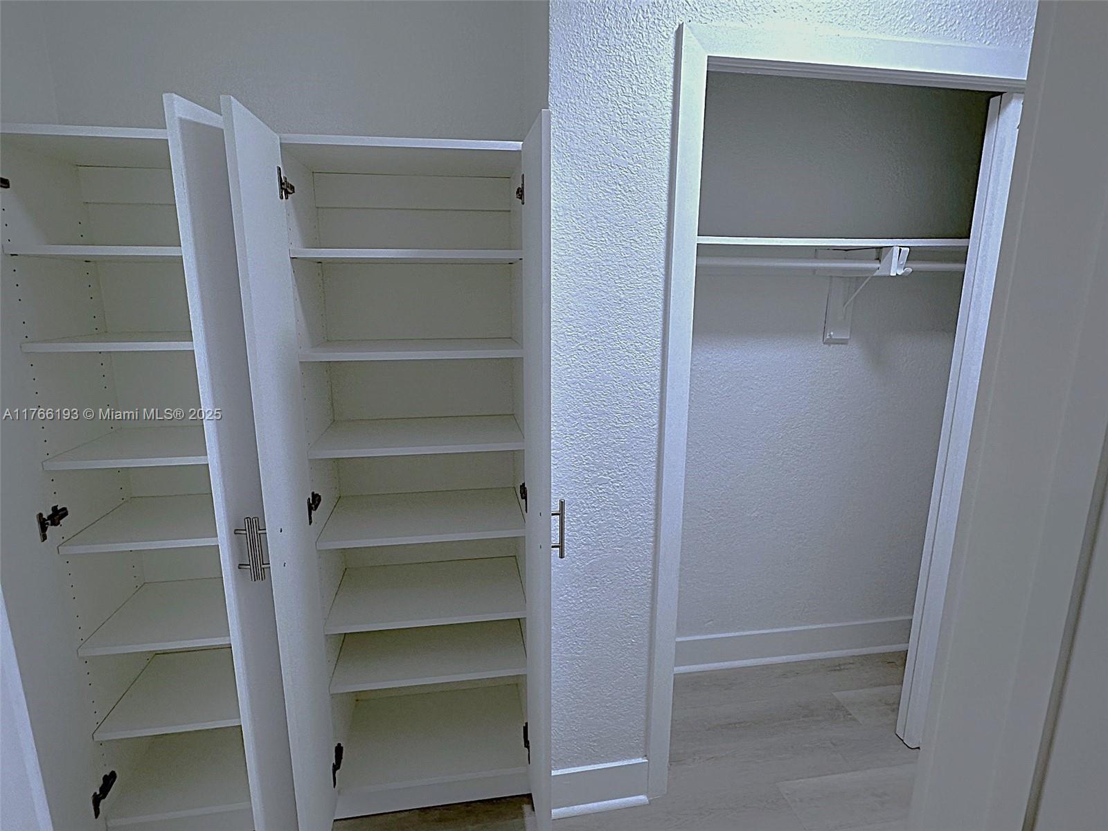 11232 Southwest 5th Street, Unit 2 Sweetwater, FL 33174 - Photo 16 of 24 a view of walk in closet with empty racks