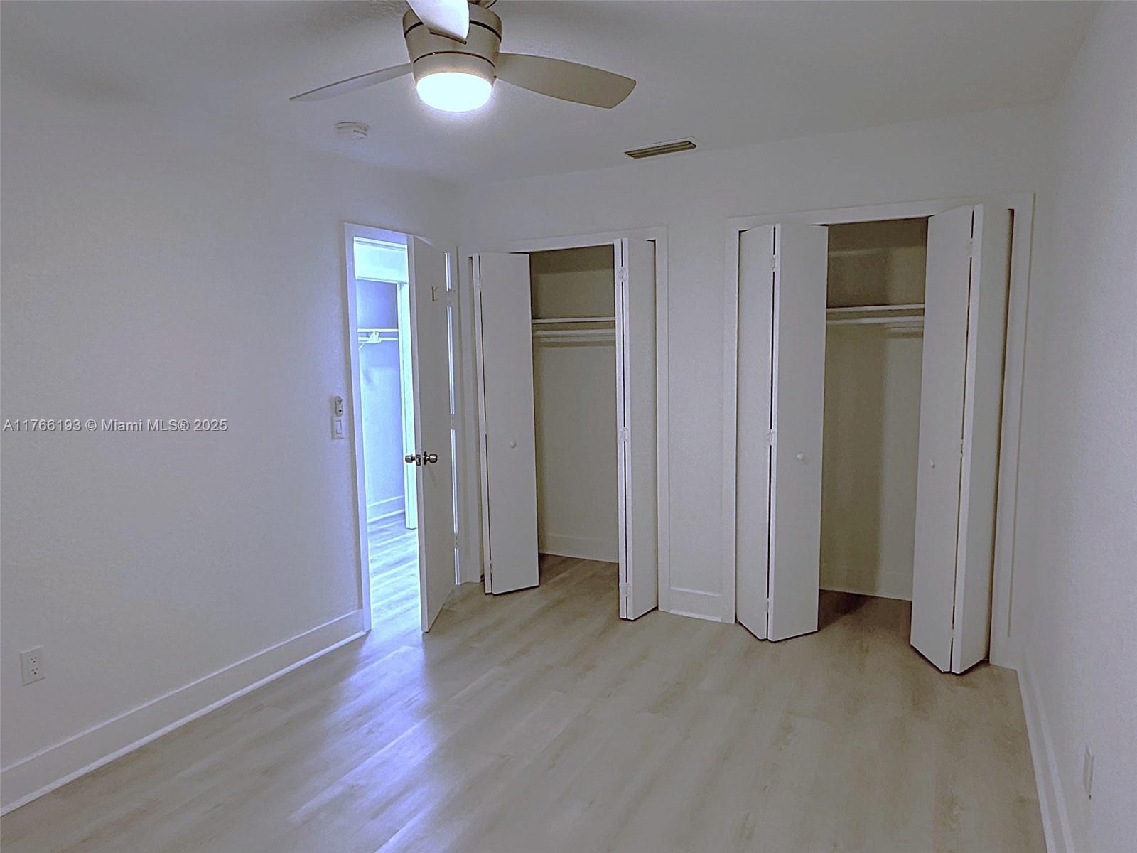 11232 Southwest 5th Street, Unit 2 Sweetwater, FL 33174 - Photo 17 of 24 an empty room with wooden floor closet and windows