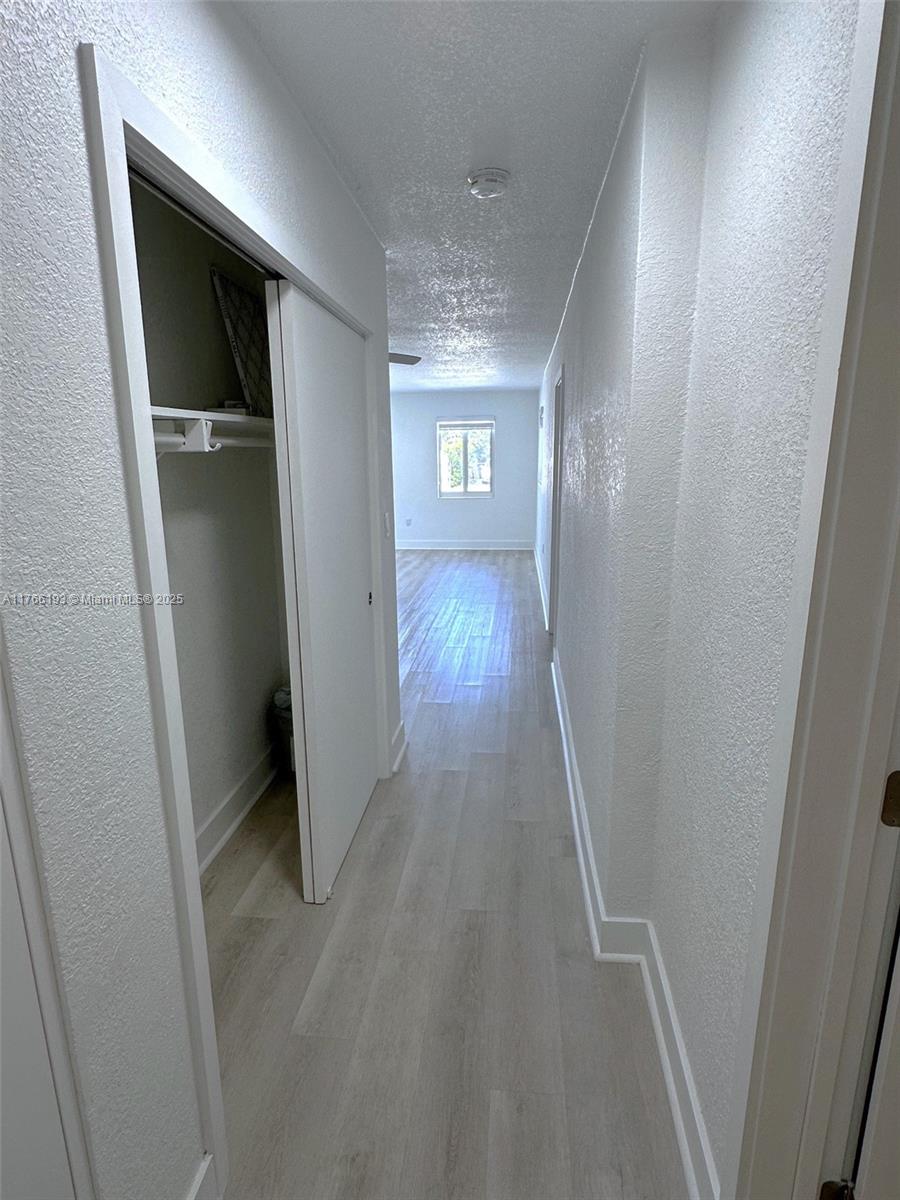 11232 Southwest 5th Street, Unit 2 Sweetwater, FL 33174 - Photo 19 of 24 a view of a hallway with wooden floor