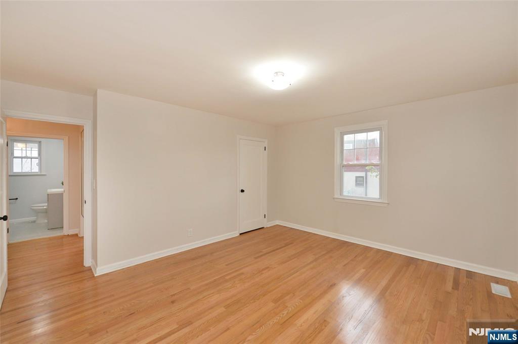 16 Liberty Street Little Ferry, NJ 07643 - Photo 11 of 16 an empty room with wooden floor and windows