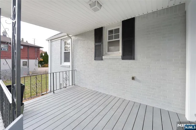 a view of a balcony with wooden floor