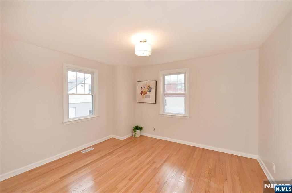 16 Liberty Street Little Ferry, NJ 07643 - Photo 8 of 16 an empty room with wooden floor and windows