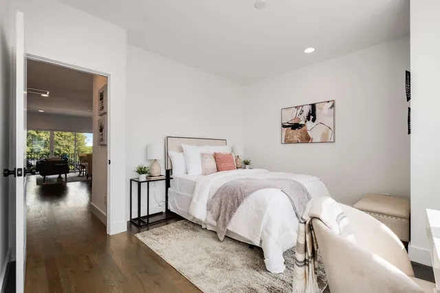 a bedroom with furniture and wooden floor
