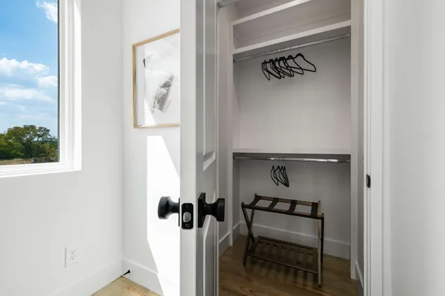 a bedroom with a bed and a view of living room