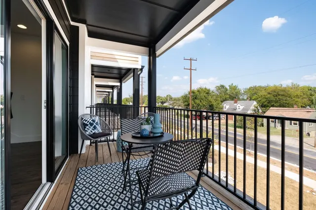 a balcony with table and chairs