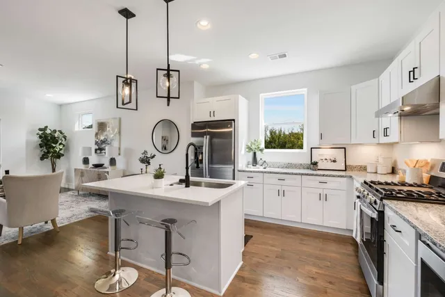 a view of center island with wooden cabinets and couch