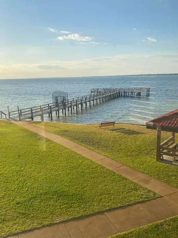 a kitchen with a table chairs and a refrigerator