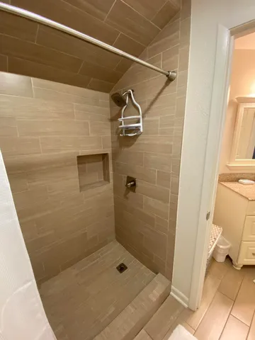 a bathroom with a toilet and a shower