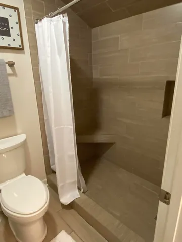 a bathroom with a sink a toilet and mirror