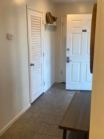 a kitchen with granite countertop a refrigerator a sink a stove a microwave and cabinets