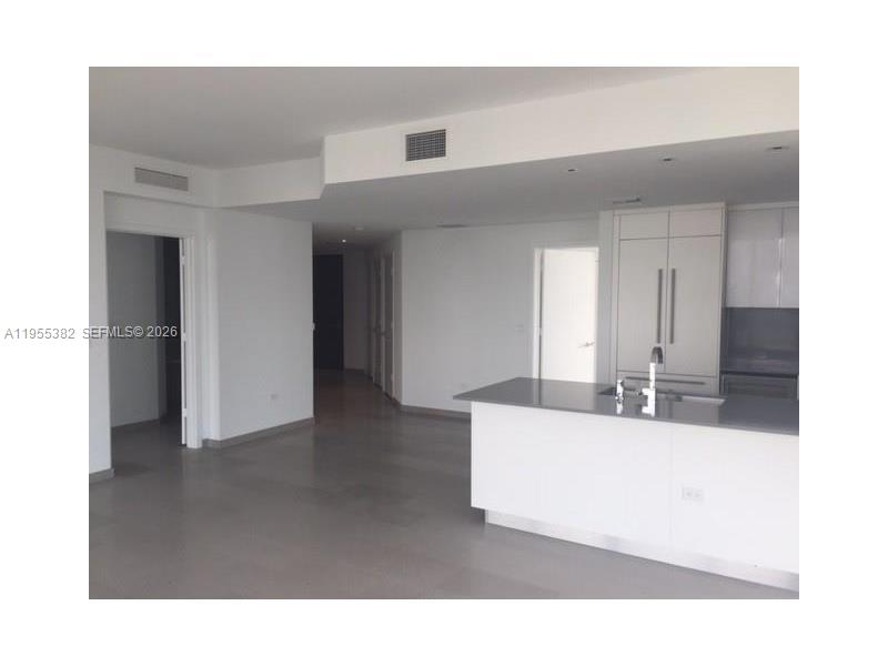 68 Southeast 6th Street, Unit 3502 Miami, FL 33131 - Photo 4 of 16 a living room with furniture and a large mirror