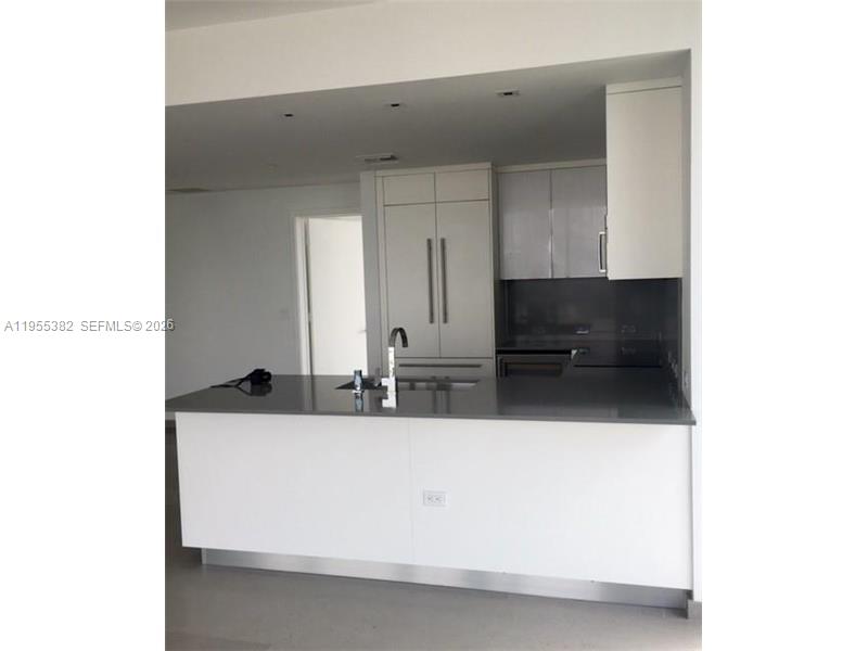 68 Southeast 6th Street, Unit 3502 Miami, FL 33131 - Photo 6 of 16 a bathroom with a sink and a mirror