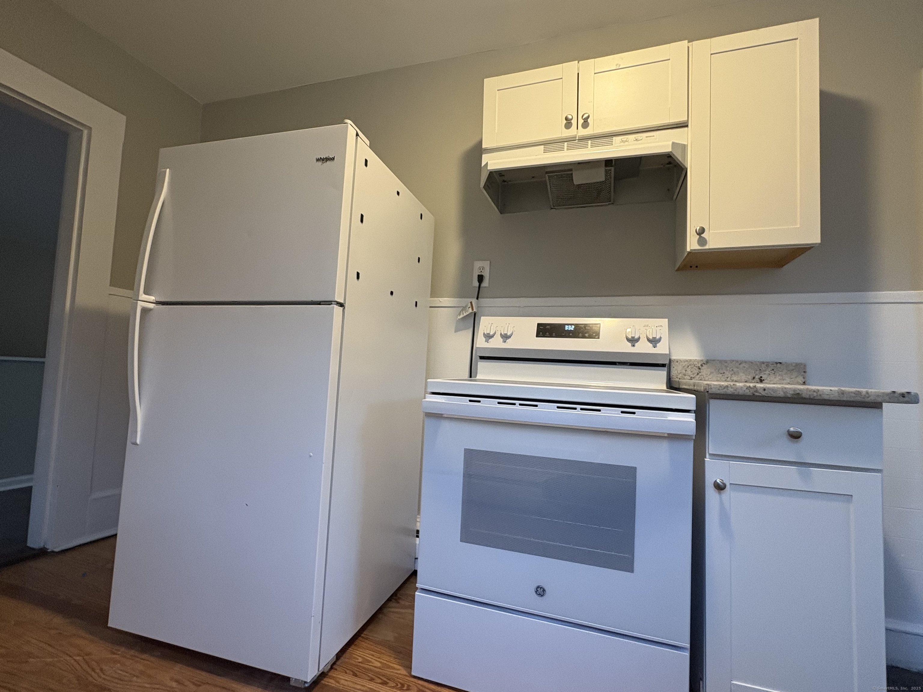 818 Pine Street, Unit 14 Bristol, CT 06010 - Photo 3 of 15 a kitchen with granite countertop white cabinets and refrigerator