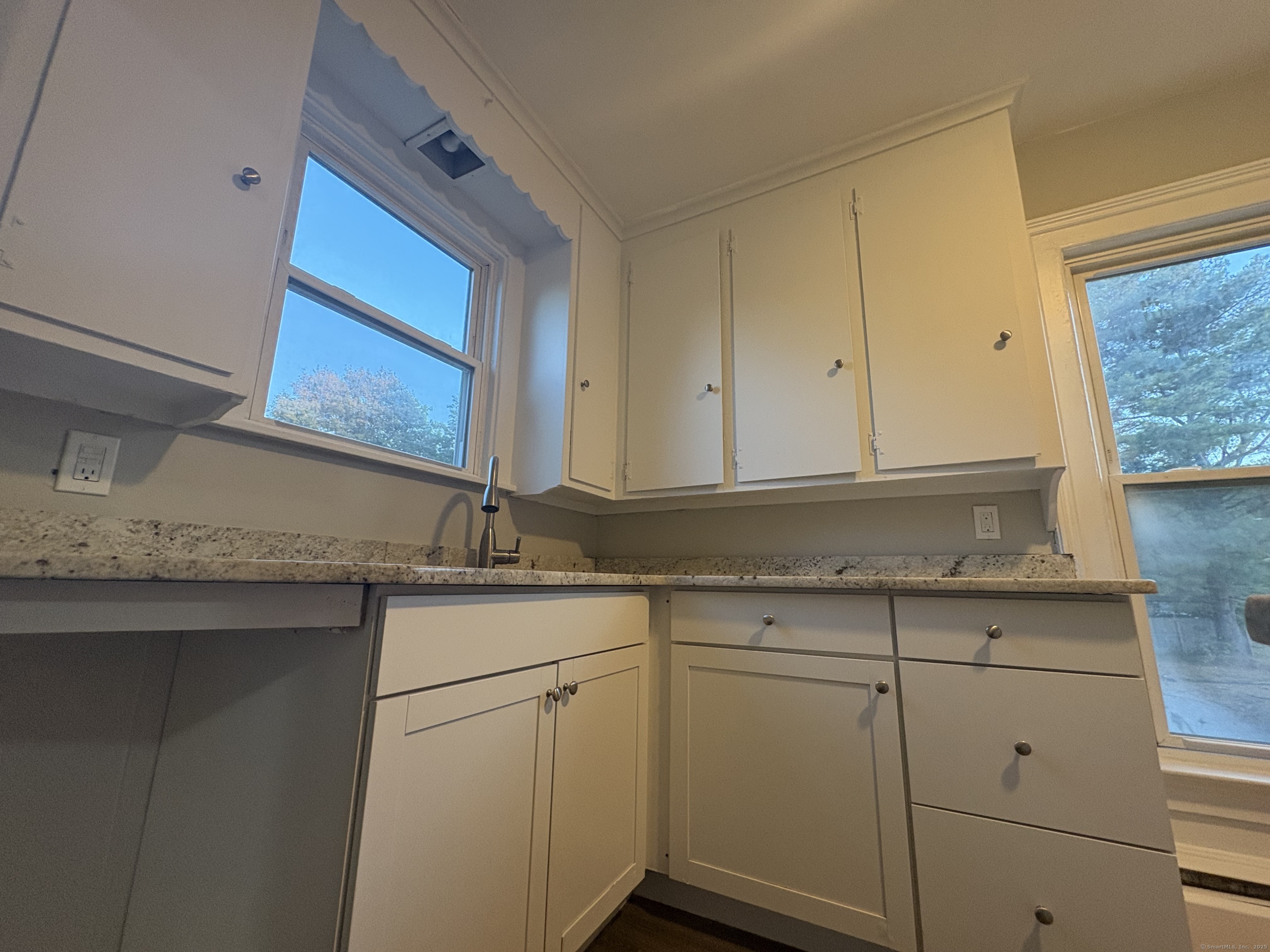 818 Pine Street, Unit 14 Bristol, CT 06010 - Photo 4 of 15 a kitchen with granite countertop white cabinets and a sink