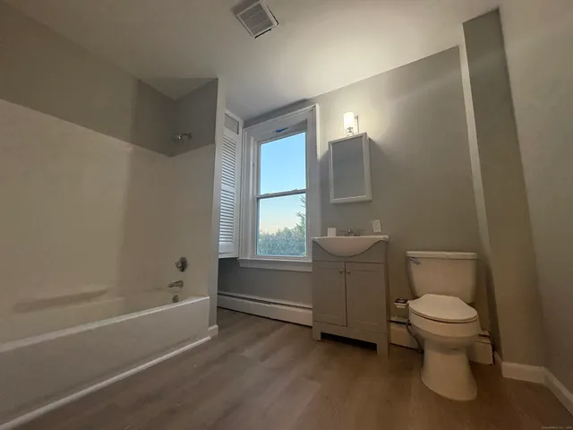 a bathroom with a toilet and a bathtub