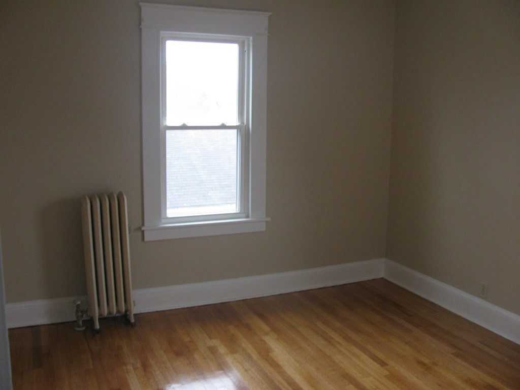 228 Edendale Street Springfield, MA 01104 - Photo 14 of 19 an empty room with wooden floor and windows
