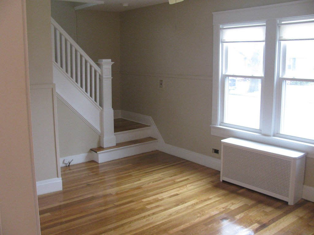 228 Edendale Street Springfield, MA 01104 - Photo 3 of 19 a view of an empty room with wooden floor and a window