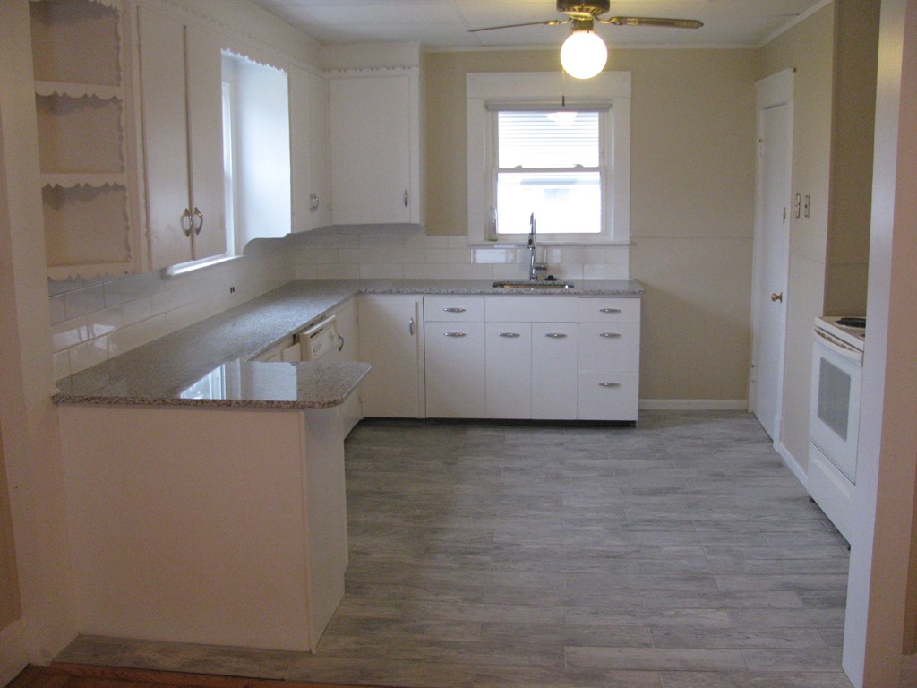 228 Edendale Street Springfield, MA 01104 - Photo 4 of 19 a room with a sink cabinets and a window