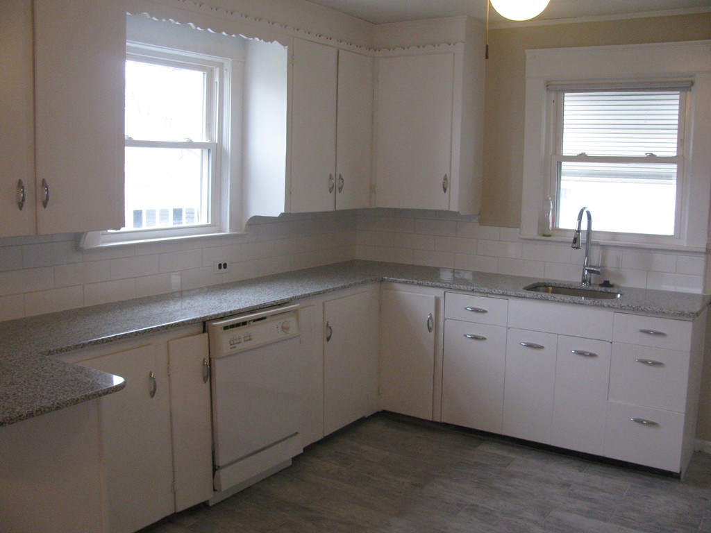 228 Edendale Street Springfield, MA 01104 - Photo 5 of 19 a kitchen with granite countertop white cabinets sink and window