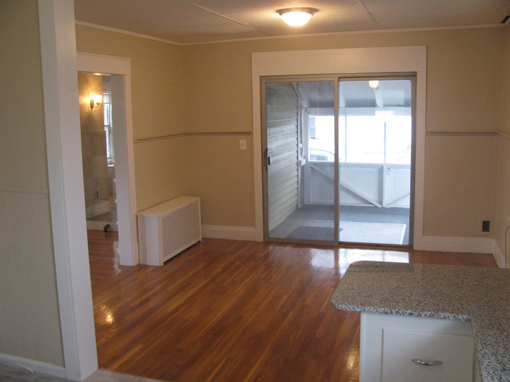 228 Edendale Street Springfield, MA 01104 - Photo 7 of 19 a view of a hallway with wooden floor and cabinet