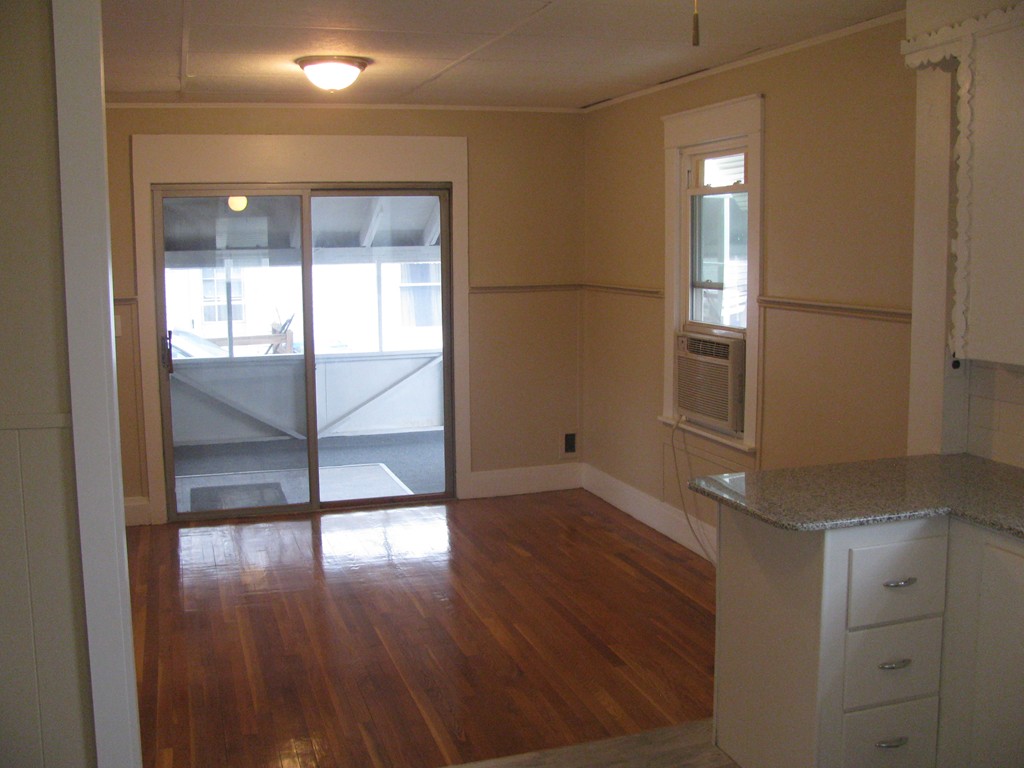 228 Edendale Street Springfield, MA 01104 - Photo 8 of 19 a view of empty room with wooden floor and fan