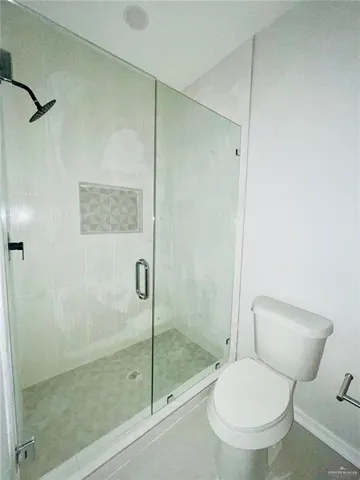 a white toilet sitting next to a bathroom