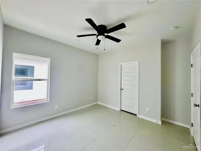 a view of a livingroom with a ceiling fan & window