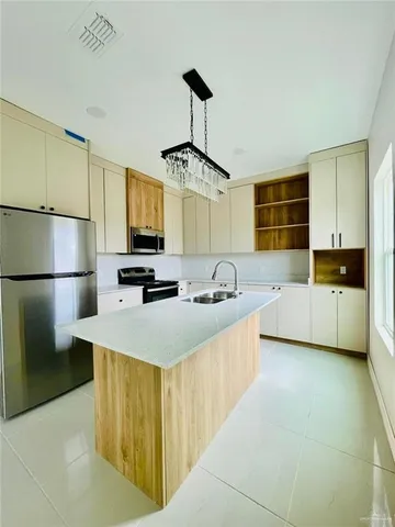 a kitchen with a sink appliances and cabinets