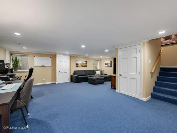a living room with furniture and a dining table with kitchen view
