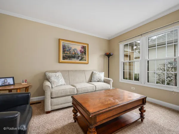 a living room with furniture a window and a bookshelf