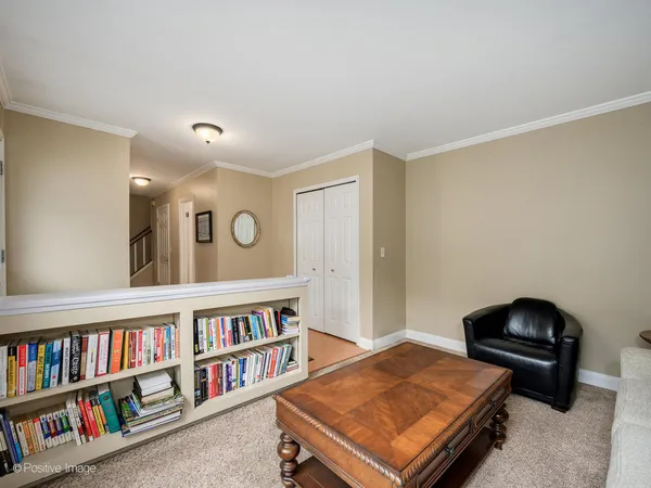 a living room with couch and a book shelf