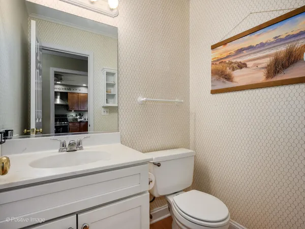 a bathroom with a sink mirror and toilet