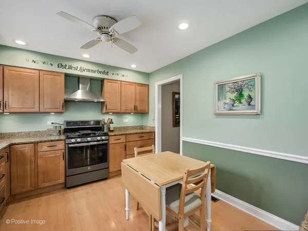 a kitchen with stainless steel appliances granite countertop a stove a sink dishwasher and a refrigerator