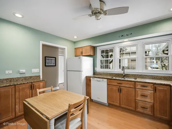 a kitchen with a stove a sink dishwasher and a refrigerator