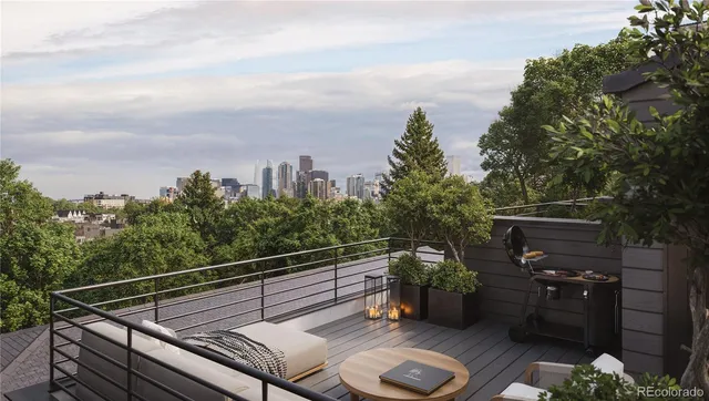 a view of a roof deck with wooden fence and trees