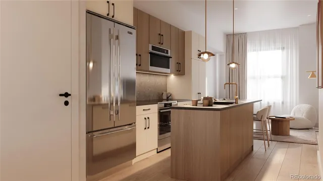 a kitchen with stainless steel appliances granite countertop a refrigerator and a stove