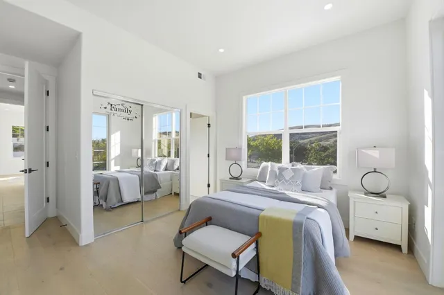 a bedroom with a bed and a couch