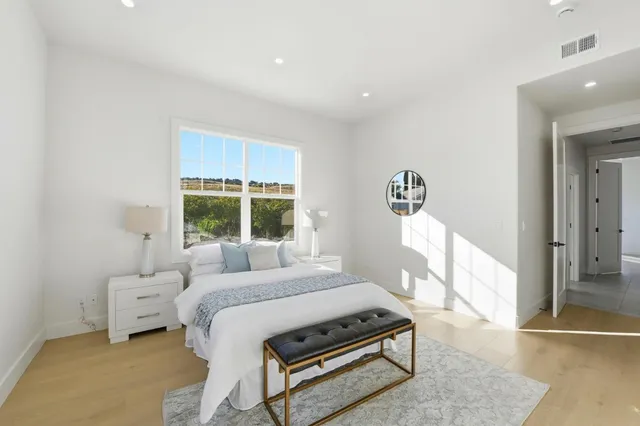 a bedroom with a bed and a large window