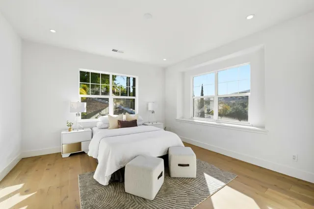 a bedroom with a bed and glass window